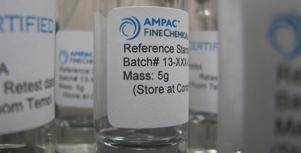 a close up image of several small clear glass bottles full of a clear chemical with the Ampac Fine Chemicals label on each bottle
